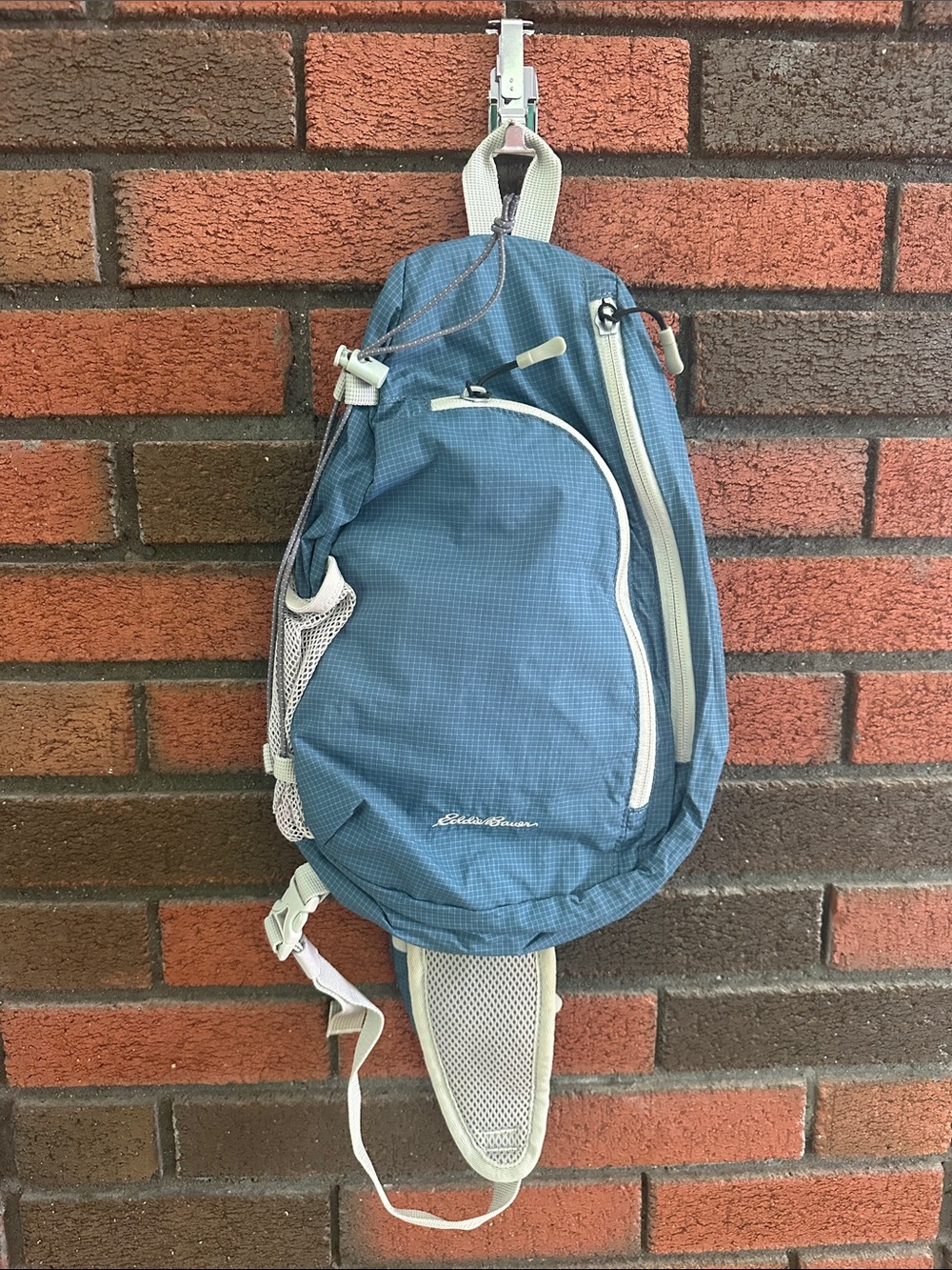 Eddie Bauer blue sling backpack with cream trim